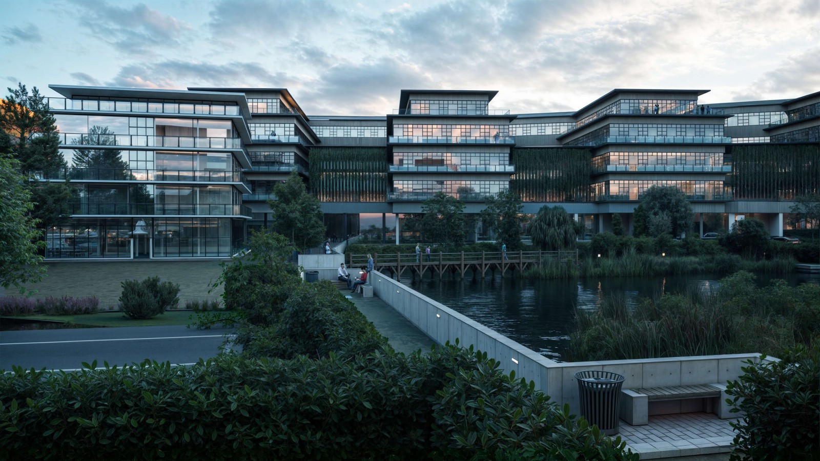 Ansicht der neuen Gebäude auf dem Europarc Dreilinden bei Sonnenaufgang, im Vordergrund eine große Wasserfläche.